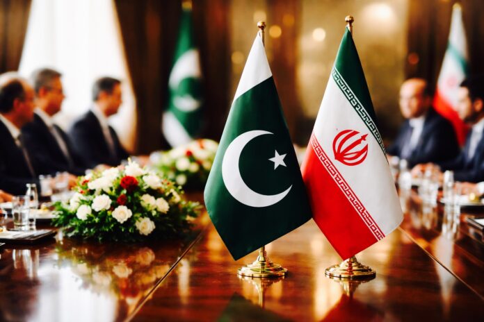 Pakistan and Iran flags displayed during diplomatic meeting