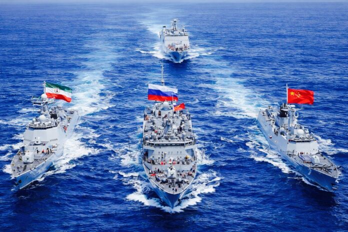 Warships from Iran, Russia and China sailing in formation during joint naval exercises in the Indian Ocean