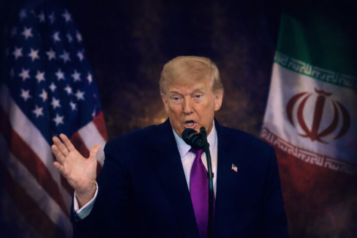 Donald Trump speaking as US and Iran flags appear in background